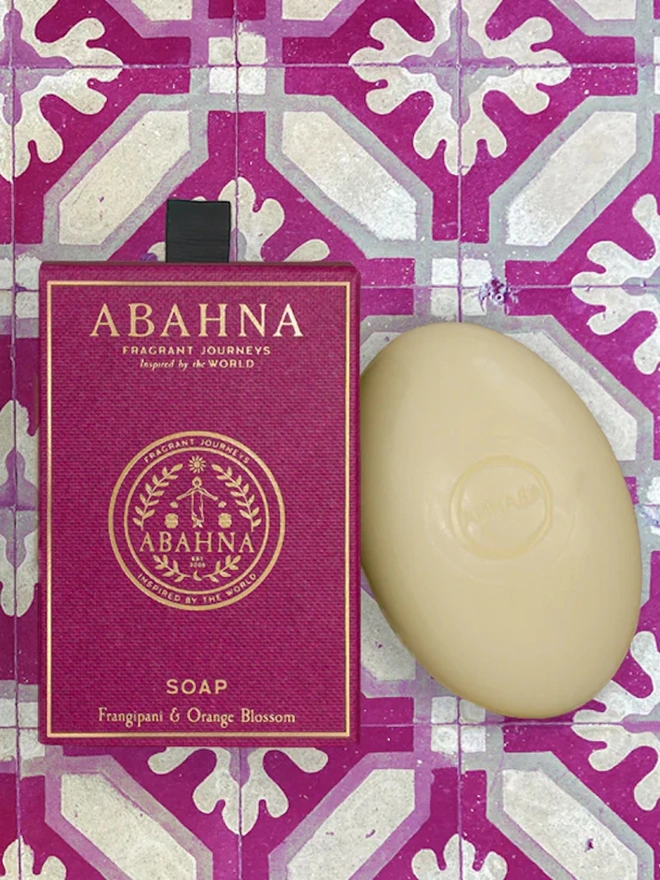 purple box next to white bar of soap on purple tile