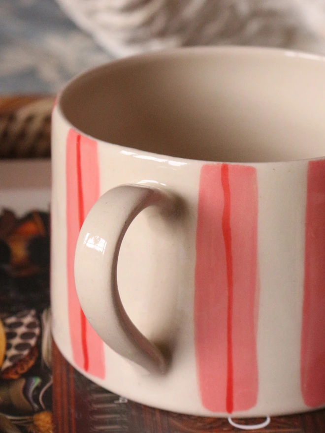 pink and red stripe mug close up of the handle for tea lovers