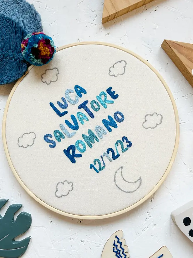 custom embroidered hoop. cotton hoop embroidered with blue lettering.