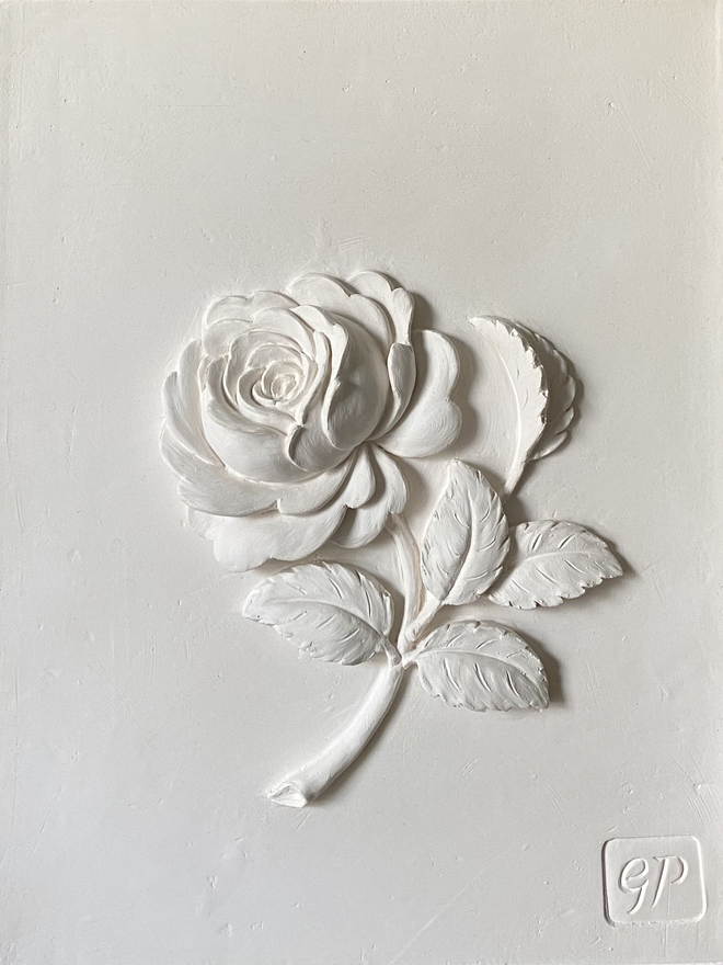 Detail of plaster of Paris bas-relief wall sculpture with Old Garden Rose flower design 