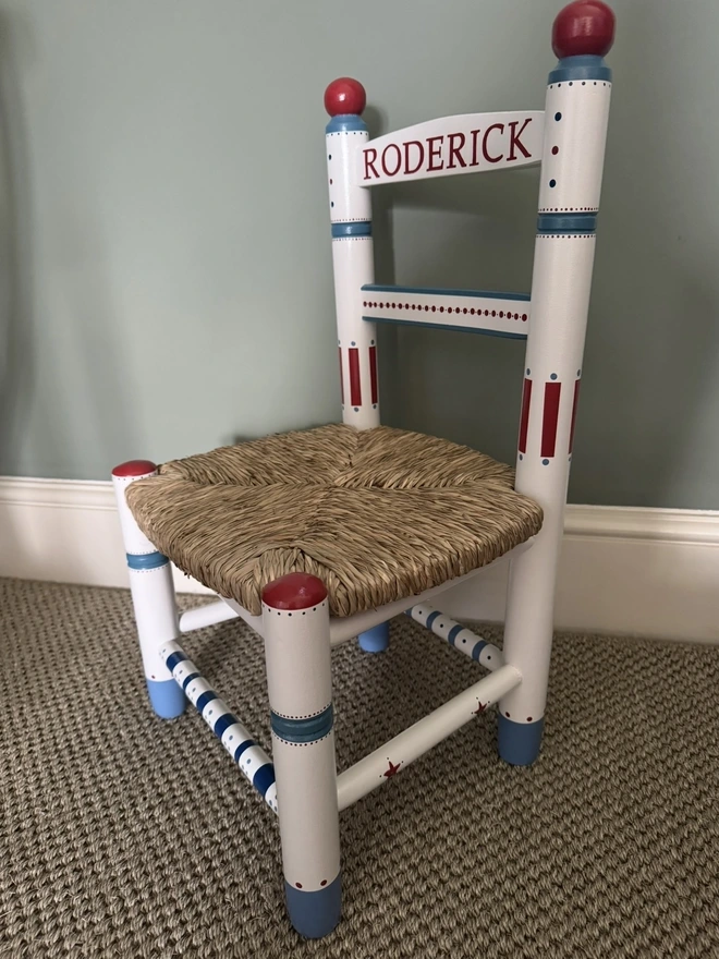 Mimi & Mots hand-painted christening chair with blue dots and red stripes. 
