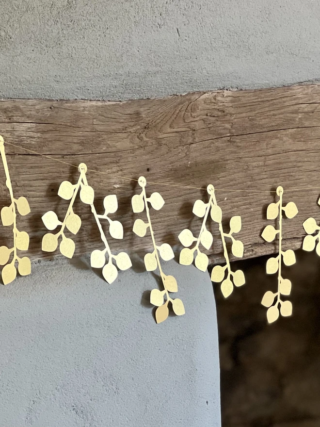 Gold Berry Paper Garland reflecting sunlight 