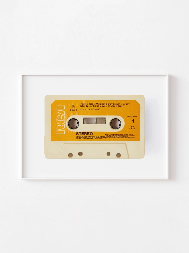 david bowie rise and fall of ziggy stardust cassette print. framed print hung on white wall.