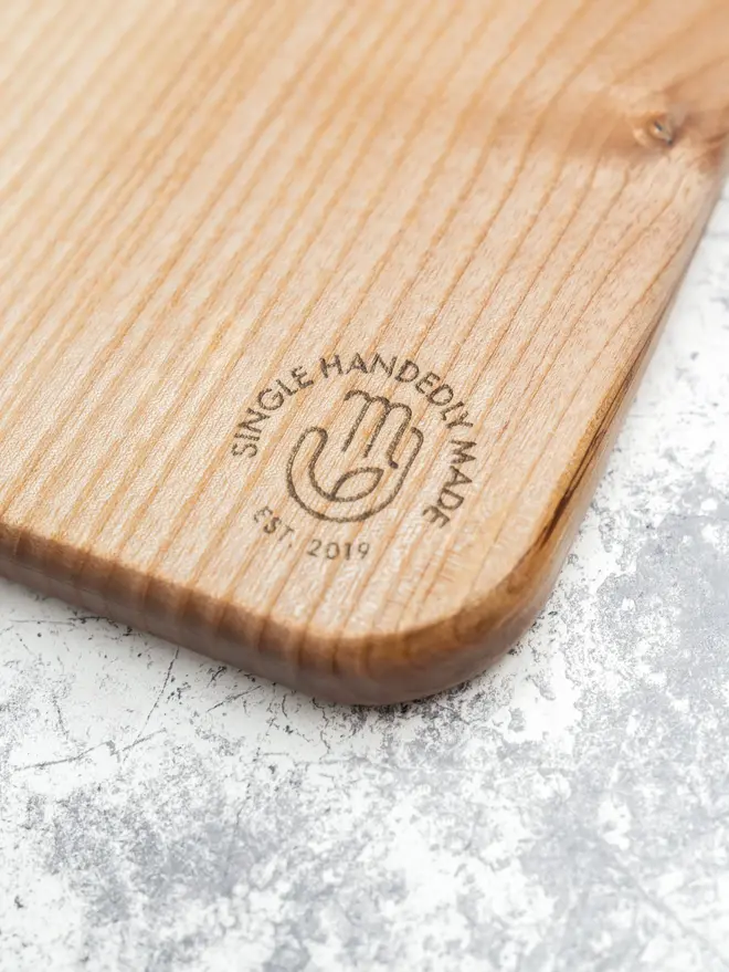 Medium Serving Board, on a marble surface. 