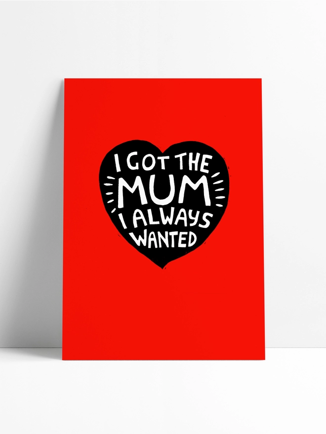 A red Woodism print unframed sitting in a limbo background. There is a heart in the middle of the print with hand crafted typography which reads: 'I Got The Mum I Always Wanted.' 