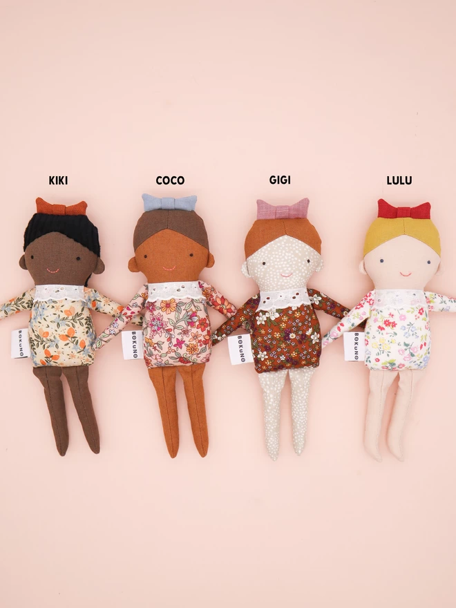 four diverse little girl dolls 