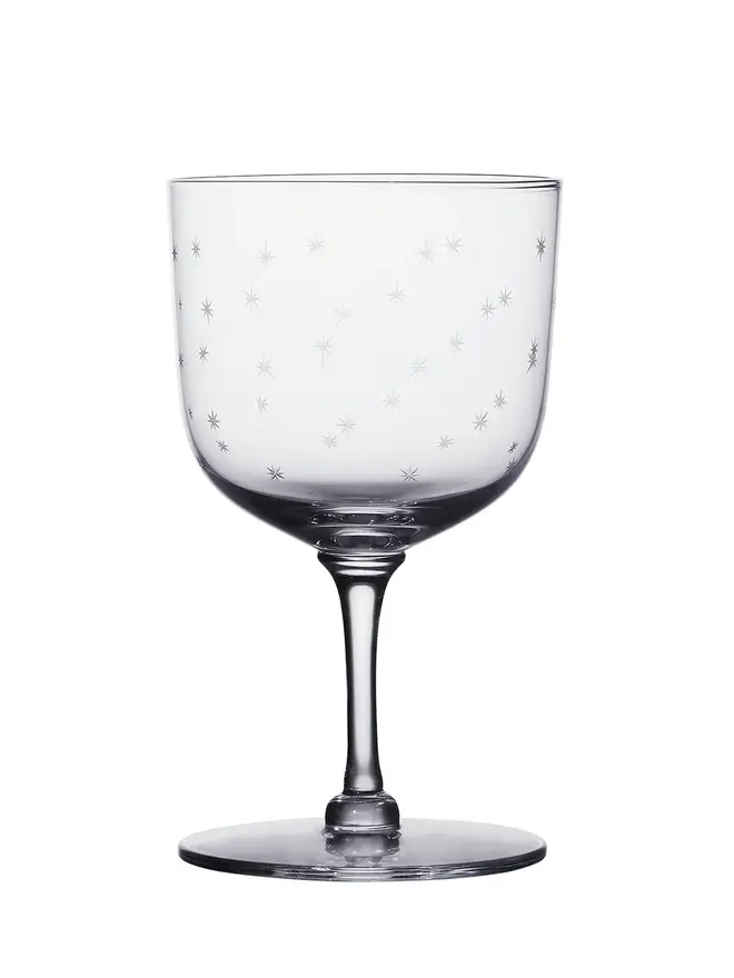 'daphne' engraved stars wine glass. a crystal wine glass with star detailing.