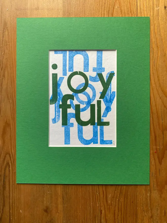 Joyful letterpress poster in green mount