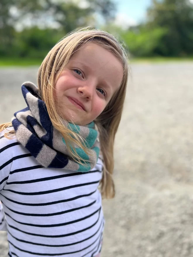 Jade mushroom navy stripe snood being worn by child