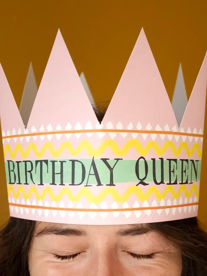 pink and yellow paper crown card with birthday queen text