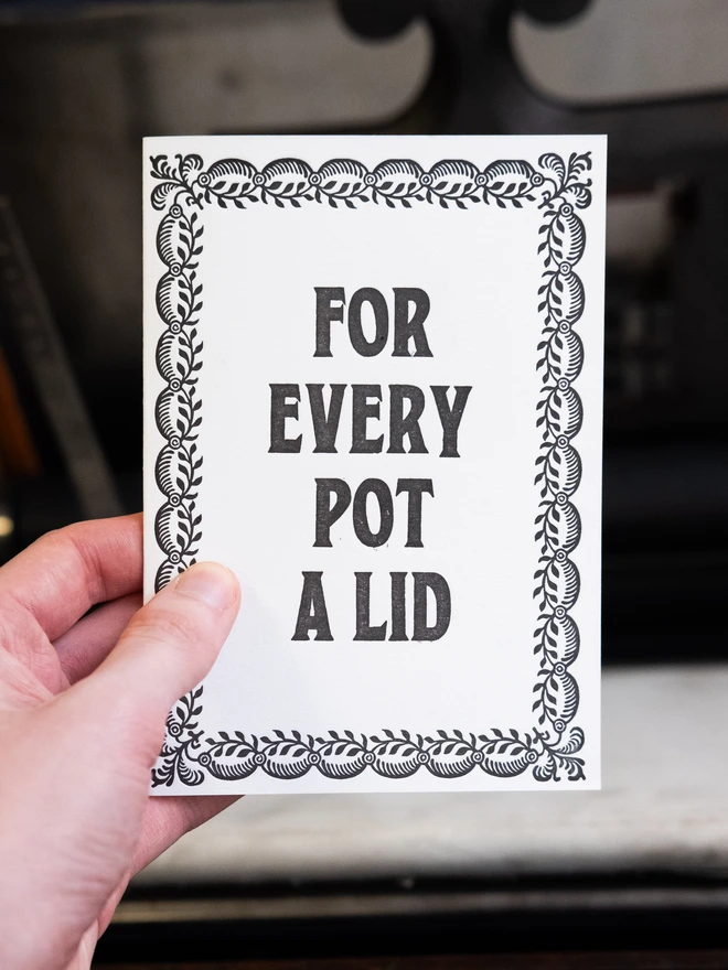 Letterpress card with text design "For Every Pot A Lid," surrounded by vintage border of leaves.