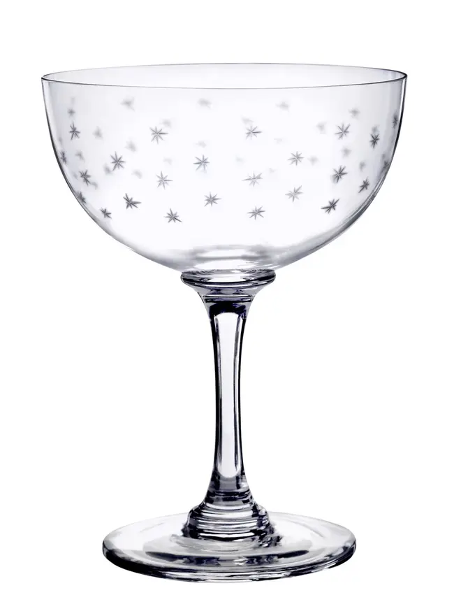 engraved stars crystal champagne saucers. a coupe champagne glass patterned with small stars.