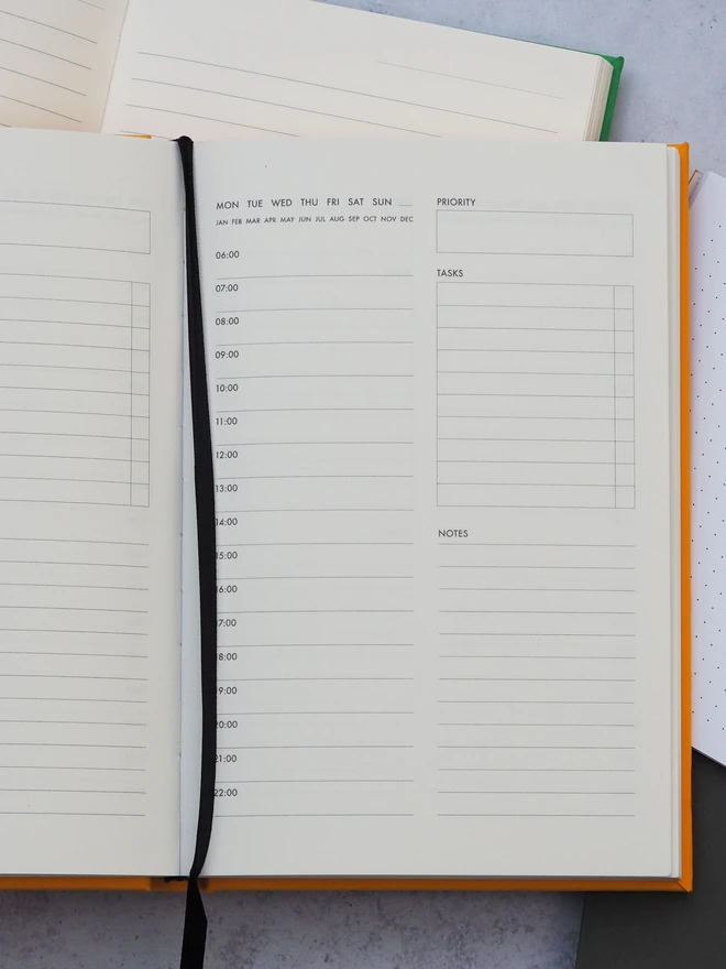 an open journal on a table showing a daily planner page template