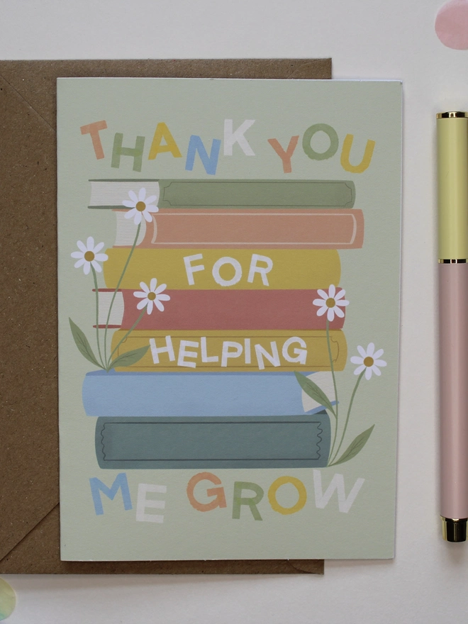 'thank you for helping me grow' illustrated card. green card with illustrated books and flowers.