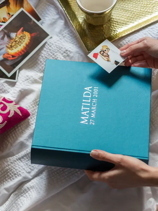 Beautiful Personalised Photo Album for Birthday or New Baby about to be opened on a bed. 