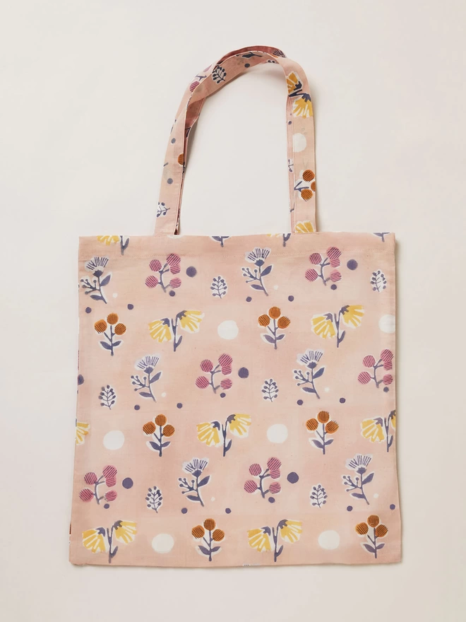Block printed small scale floral design on a tote bag