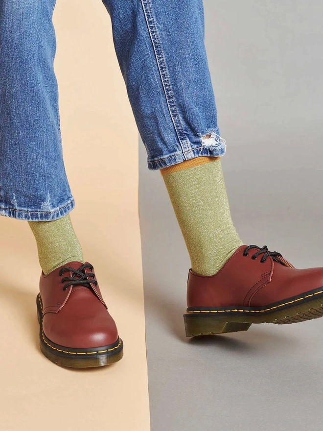 Women's Organic Cotton Ankle Socks Packs (Sets Of 3), a person wearing a pair of colourful patterned socks. 