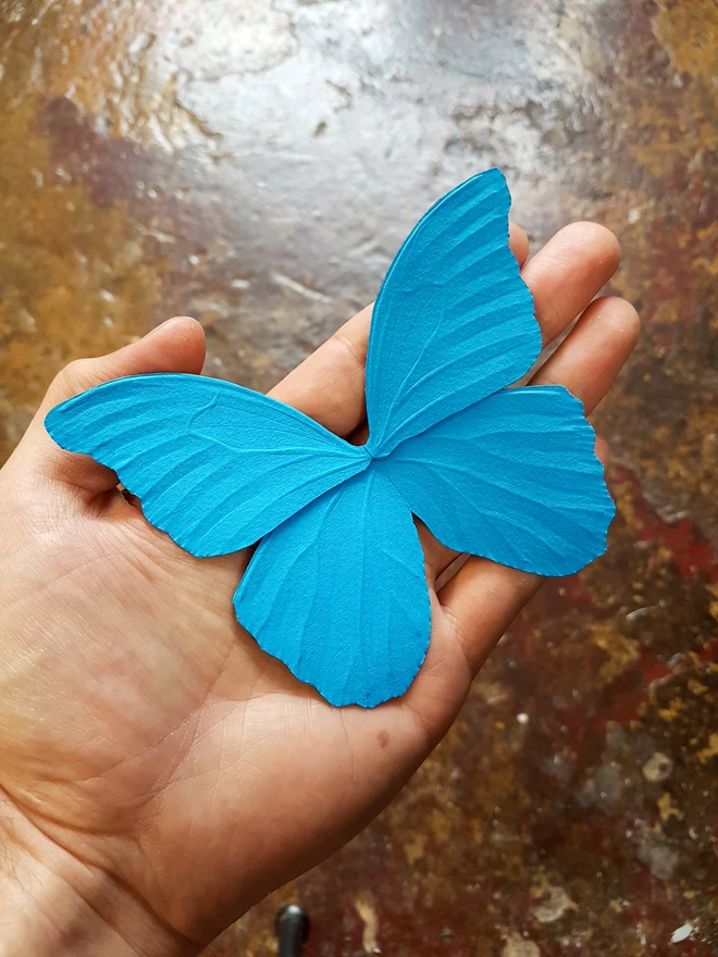 Handmade paper butterfly wings in hand