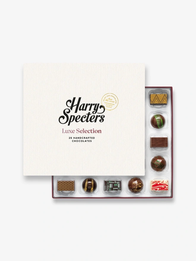 A box of 25 chocolates partially covered by a Harry Specters lid