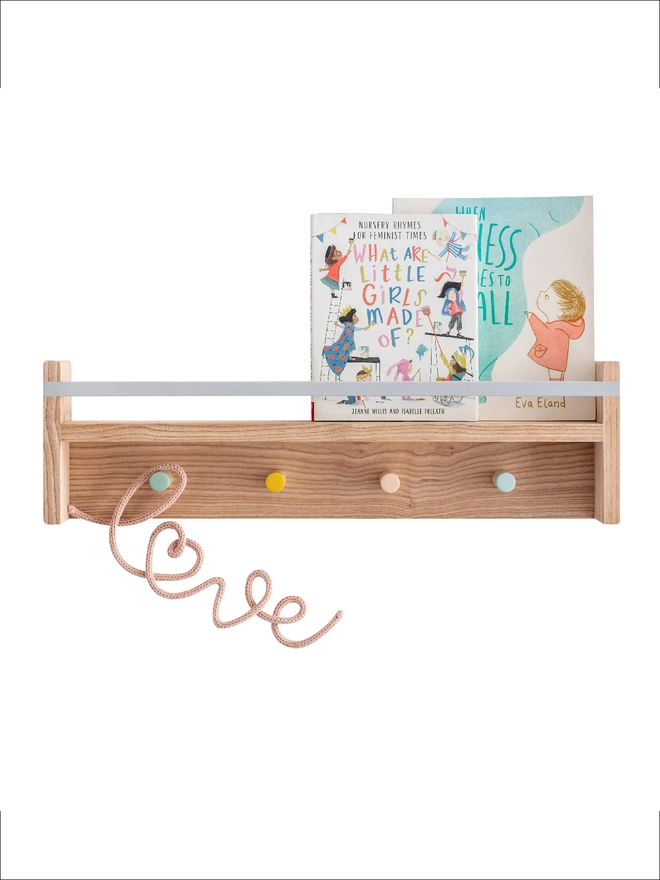 A solid ash wood pegrail bookshelf with colourful painted pegs and rail 