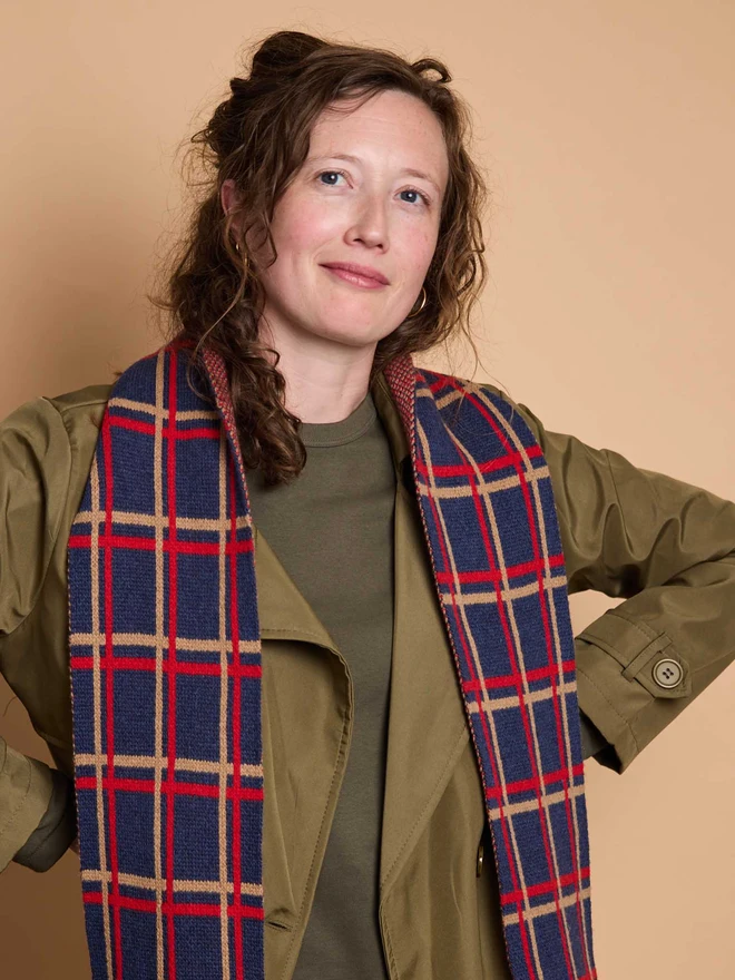 Blue And Red Patterned Wool Scarf Modelled By A Woman In A Green Coat
