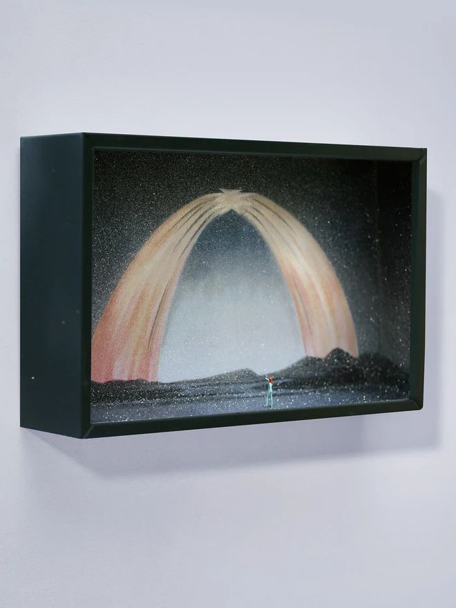 Miniature scene in an artbox showing a tiny David Bowie looking back at a sparkling cosmic northern lights backdrop.