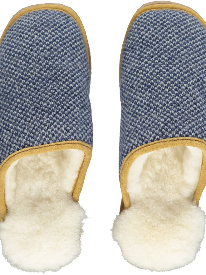 Lambswool & Sheepskin Slippers, a pair of colourful lambswool and sheepskin slippers sitting on a plain white surface. 