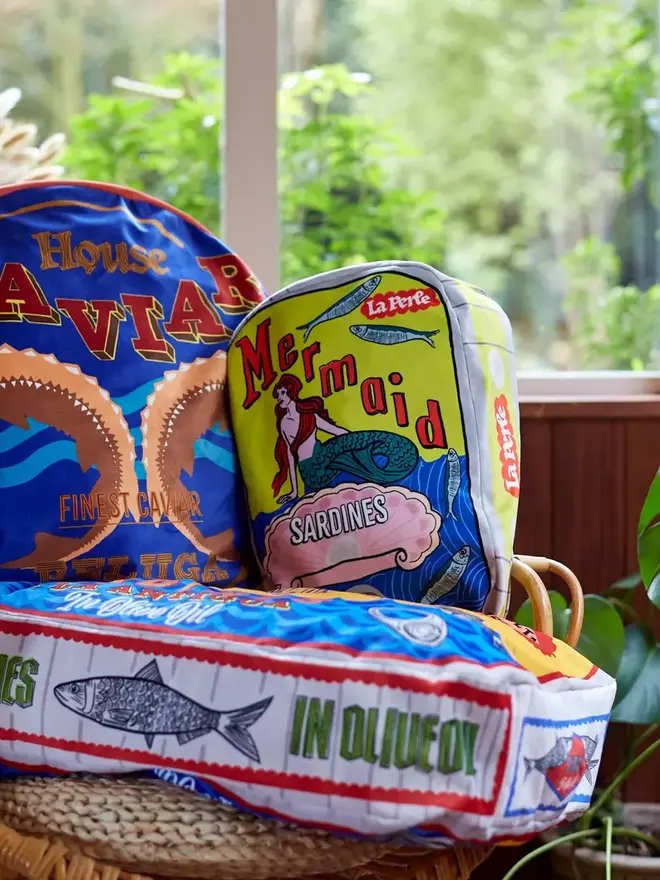 Mermaid Tin Cushion, a decorated mermaid cushion sitting on a window sill. 