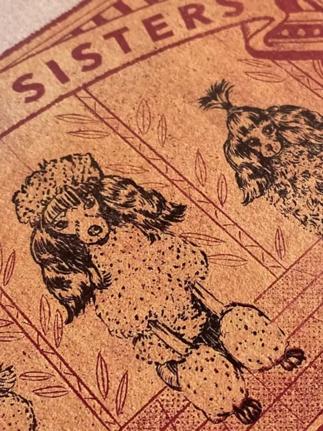 An illustrated image of a vintage matchbox. The matchbox is a faded golden yellow with red details. It features three poodles standing side-by-side. The poodles are highly stylized, with fluffy fur and topiary-like shapes. The poodle on the left has a puffball on its head, the middle poodle has a large, rounded bouffant, and the poodle on the right has its hair styled into a single upright spike. Above them, the text reads, "THE SLAY SISTERS," and below them, it says, "CARIDADE TRADE MARK IMPREGNATED SAFETY MATCH." The matches on the side of the box are a heart shape, and the entire image has a grainy texture, like it was screen-printed.
