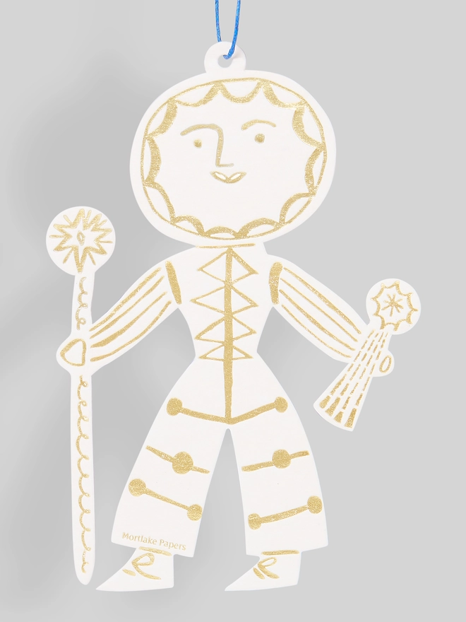 Decorative Sun Folk ornament in gold and white on a gray background