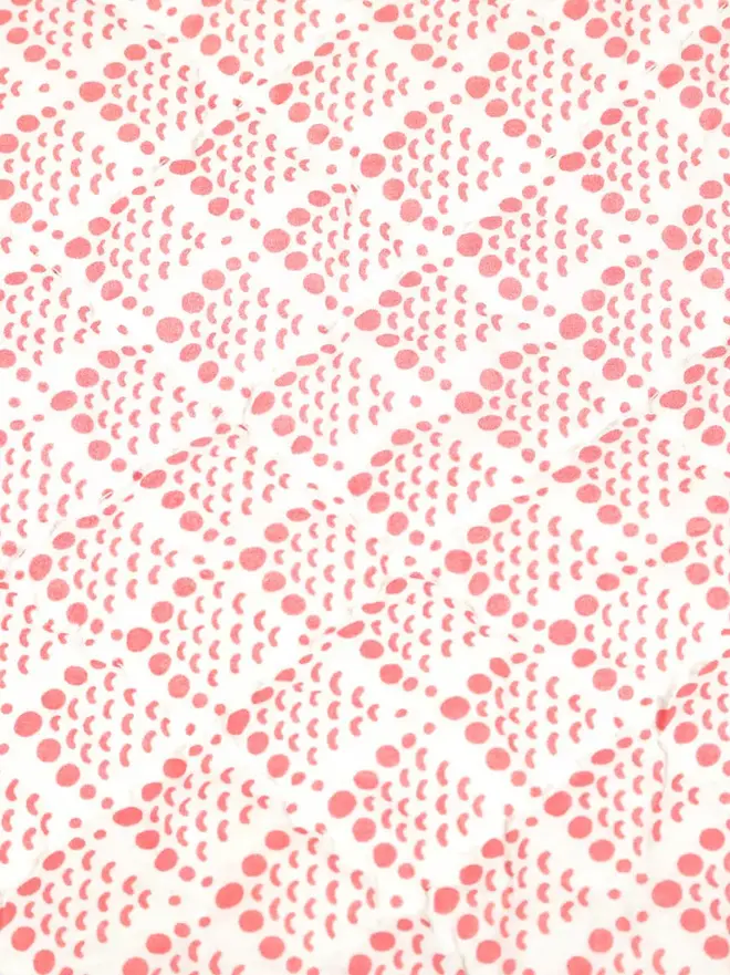 Pink Coral Reef Quilt, a pink quilt sitting on a white surface. 