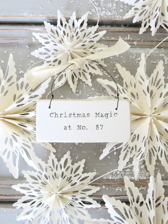 Chalky white painted wooden hanging sign with hand painted personalised Christmas Magic message