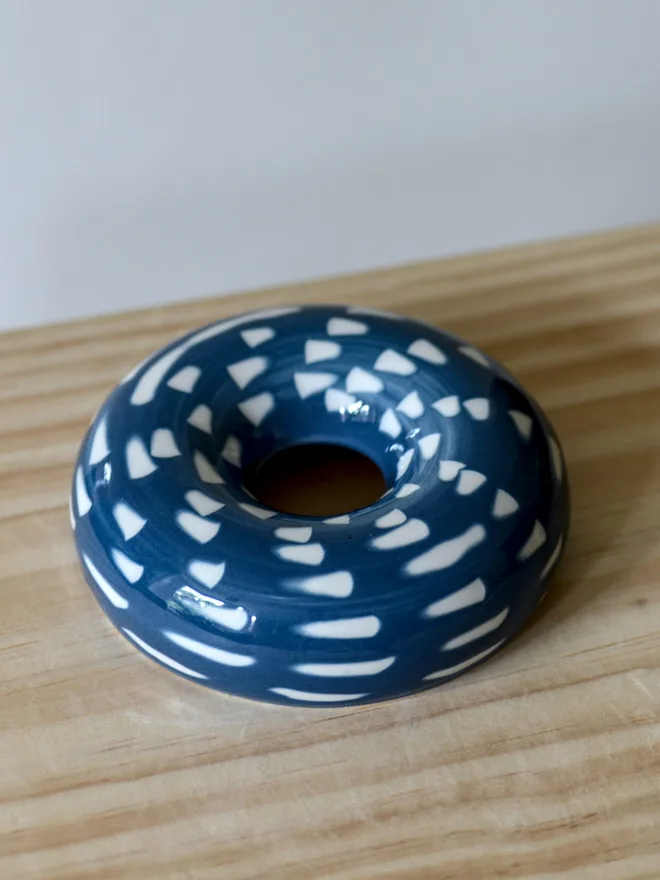 Handmade porcelain avocado planter with carved blue pattern, designed to hold an avocado seed for sprouting