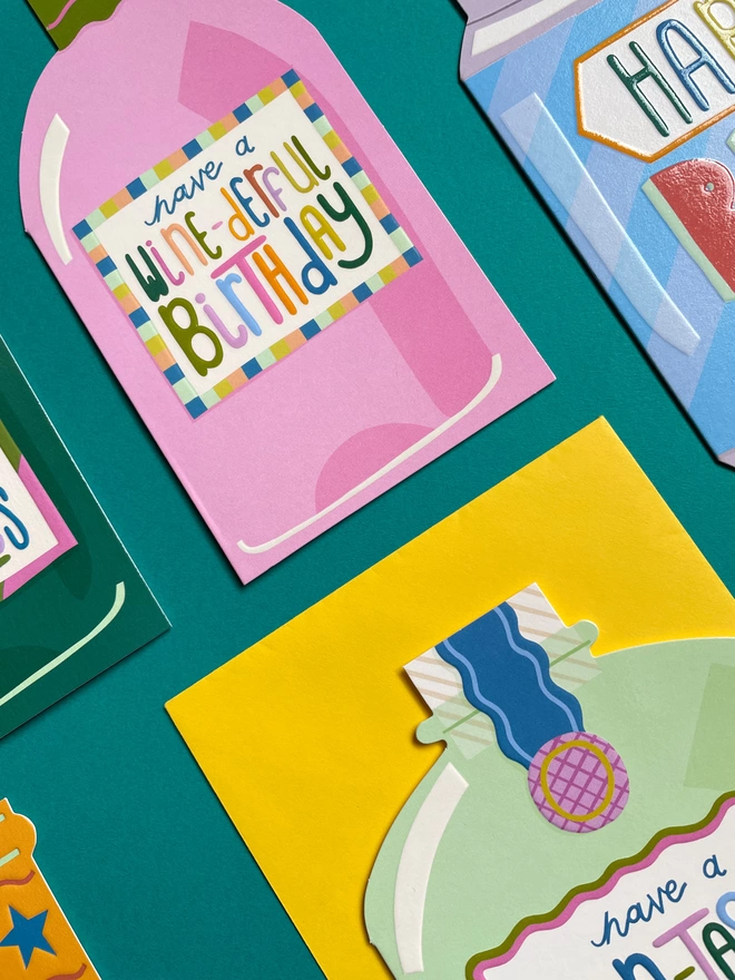A detailed closer look at the flat lay of colourful cards from the ‘Cheers’ birthday card collection. All the designs have a spot UV finish to make the vibrant details pop