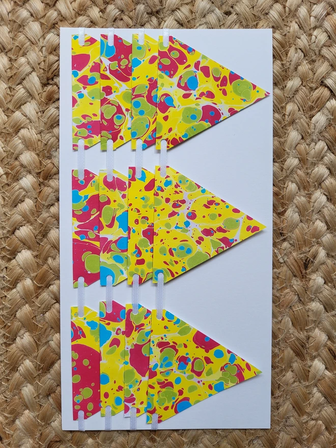 Hand-marbled paper bunting in yellow, red, green tones