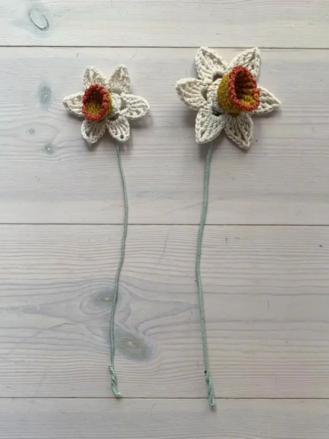 Daffodil Craft Kit, Crocheted Daffodils lying on a white wooden floor