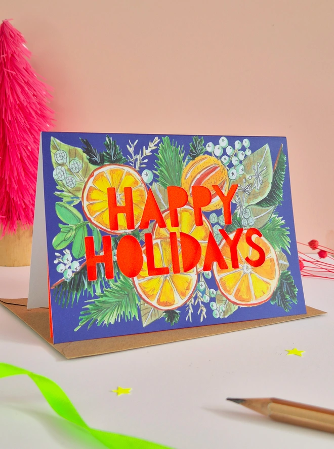 Orange Illustration Christmas Card with Happy Holidays Paper cut text with neon red backing paper 