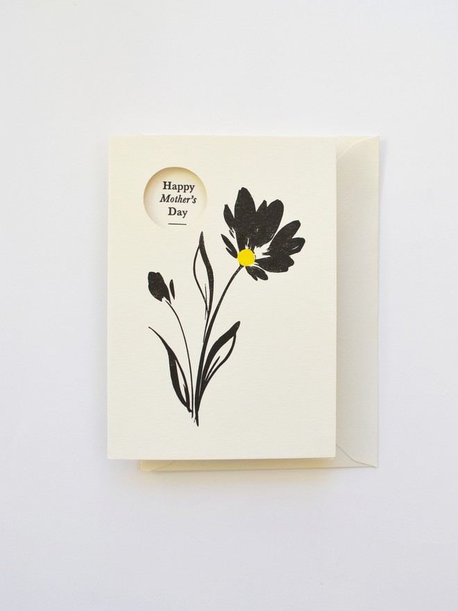 Mother's Day Greeting Card featuring black flower with a pop of yellow.  Letterpress printed with a cut-out window detail.