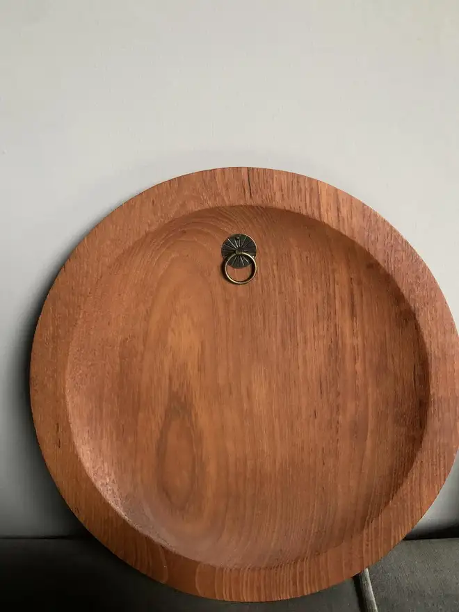 reverse of  teak plate showing hanger