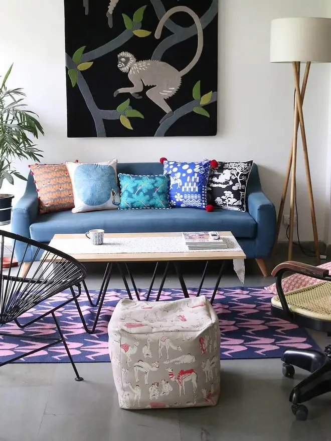Crane Flatweave Rug, a colourful rug sitting in a living room. It is accompanied by other colourful items. 