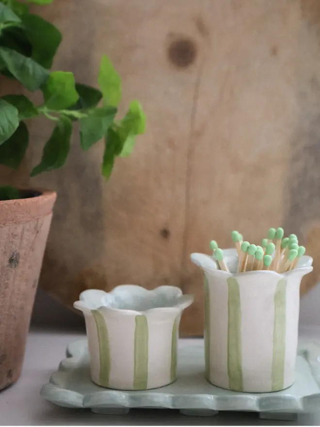 Daisy tealight holder, sage with matchstriker and bottle stands in sage