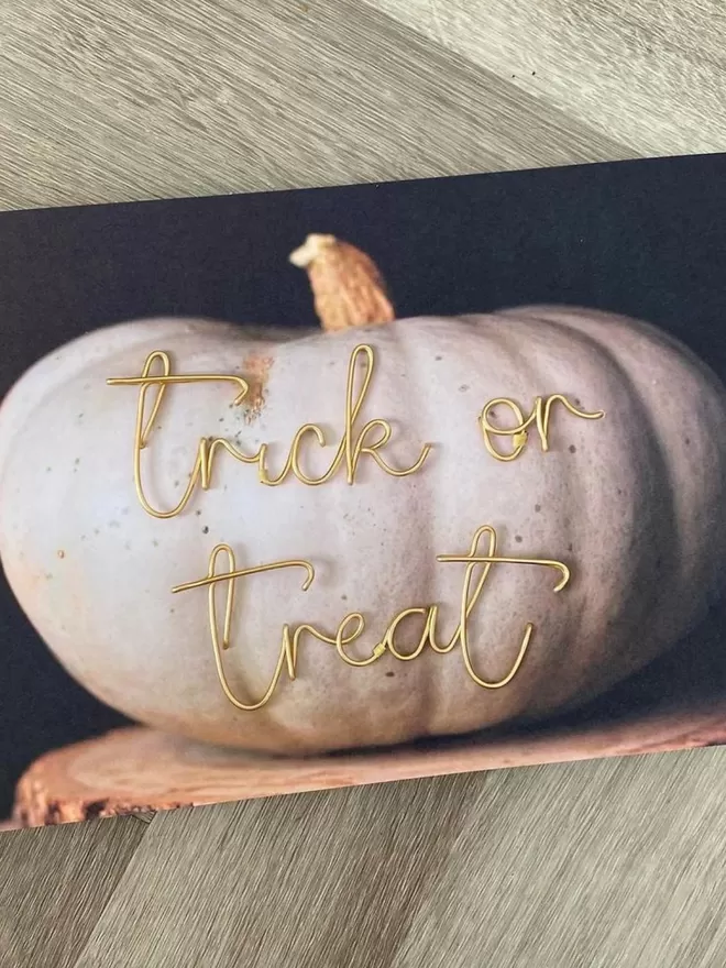 Trick or treat gold wire halloween pumpkin sign.