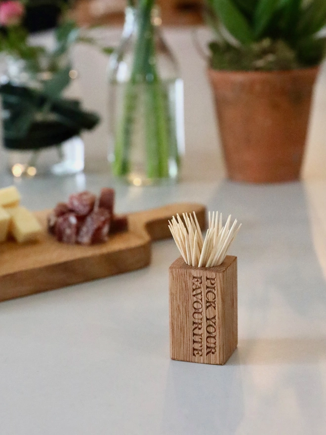 Cocktail Stick Cup with charcuterie in the background