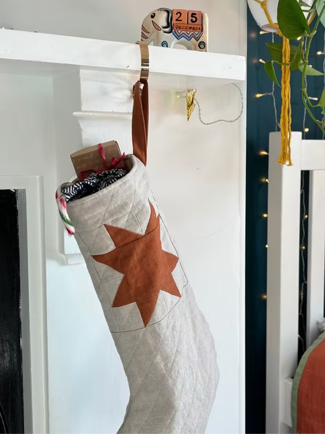 Medium Star Quilted Linen Christmas Stocking. A white and red stocking.