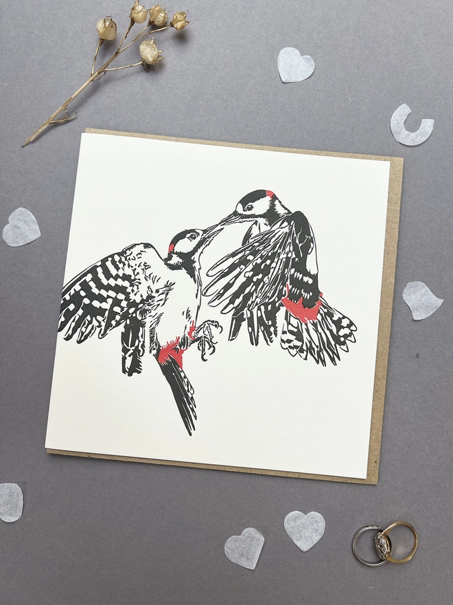 Letterpress image of two beautiful woodpeckers in love in the bold colours of black and red. 