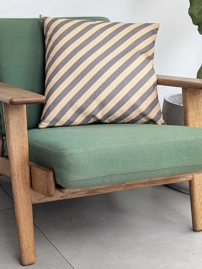 Cotton Print Patterned Cushion, a cushion sitting on a green chair in a kitchen. 