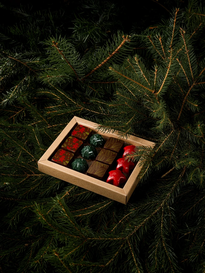 Christmas chocolate box open, showing 12 pieces of colourful festive bonbons