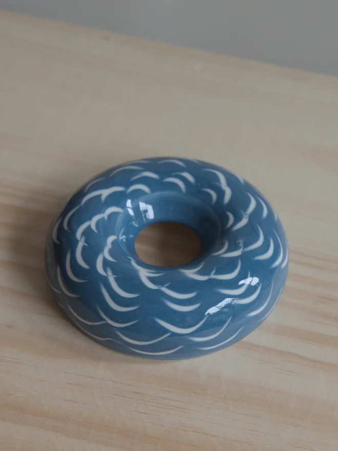 Handmade porcelain avocado planter with carved blue pattern, designed to hold an avocado seed for sprouting