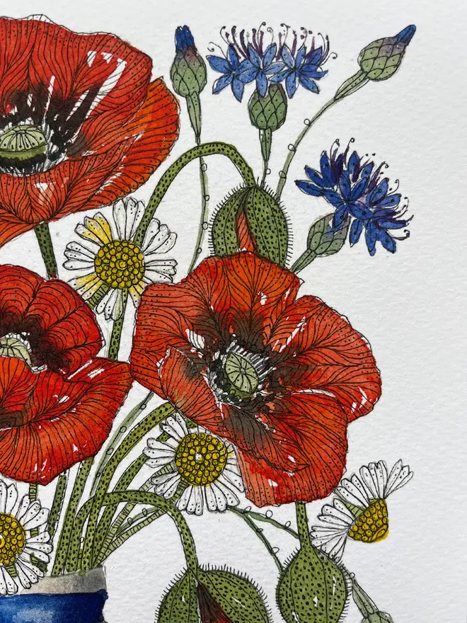 summer meadow flowers, red poppies, cornflowers and daisies in a delftware ceramic vase