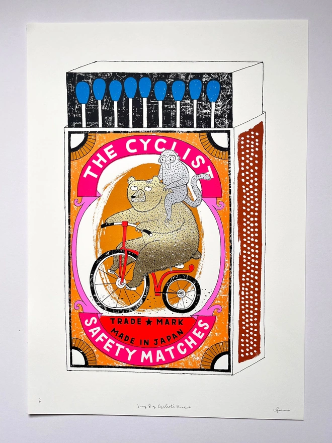 Bear On A Bike Matchbox Screenprint Big Cyclist's Burden, a colourful matchbox design in the centre of a white screenprint. 